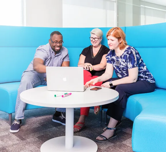 Employees looking at computer screen