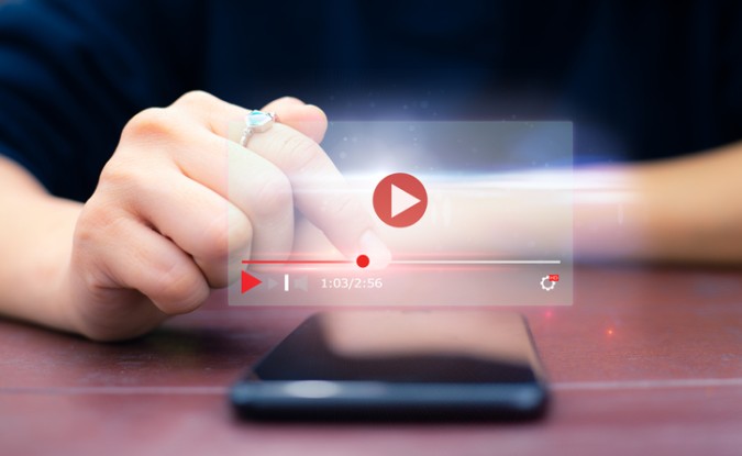 Woman streaming video on her smartphone.