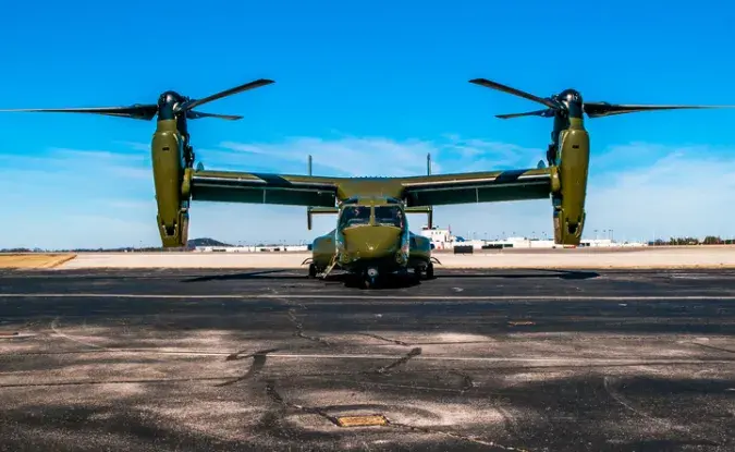 Helicopter prepares for takeoff on a landing pad.