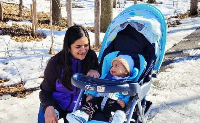 Prachi and her baby on a snowy trail.