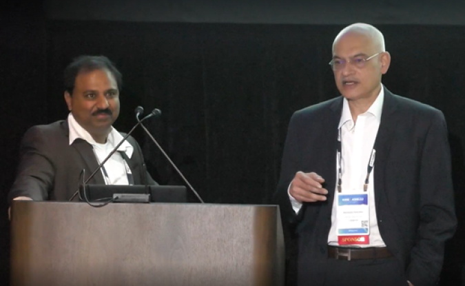 Sreekanth Patcha and Dharmendra Patwardhan of Capgemini stand side-by-side at a podium during Kinexions '22.