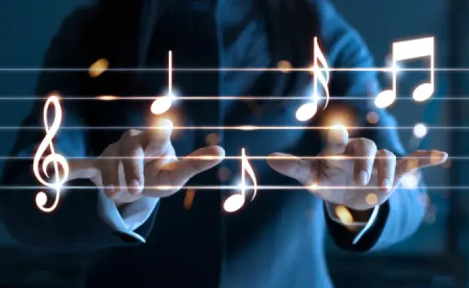 A person uses hands and fingers to conduct a superimposed graphic of glowing musical notes.