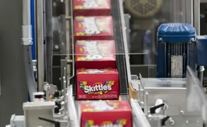 Skittles® boxes on a Mars, Incorporated factory production line.