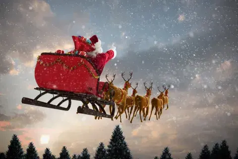 Santa Claus flying in a sled