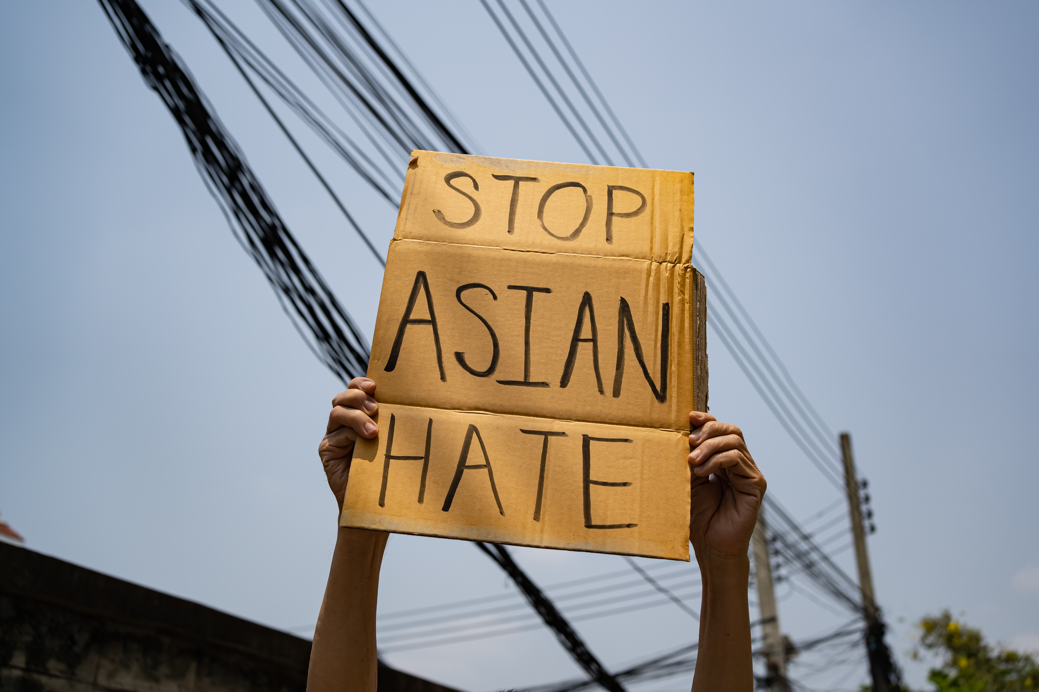 Person holding a "Stop Asian Hate" sign