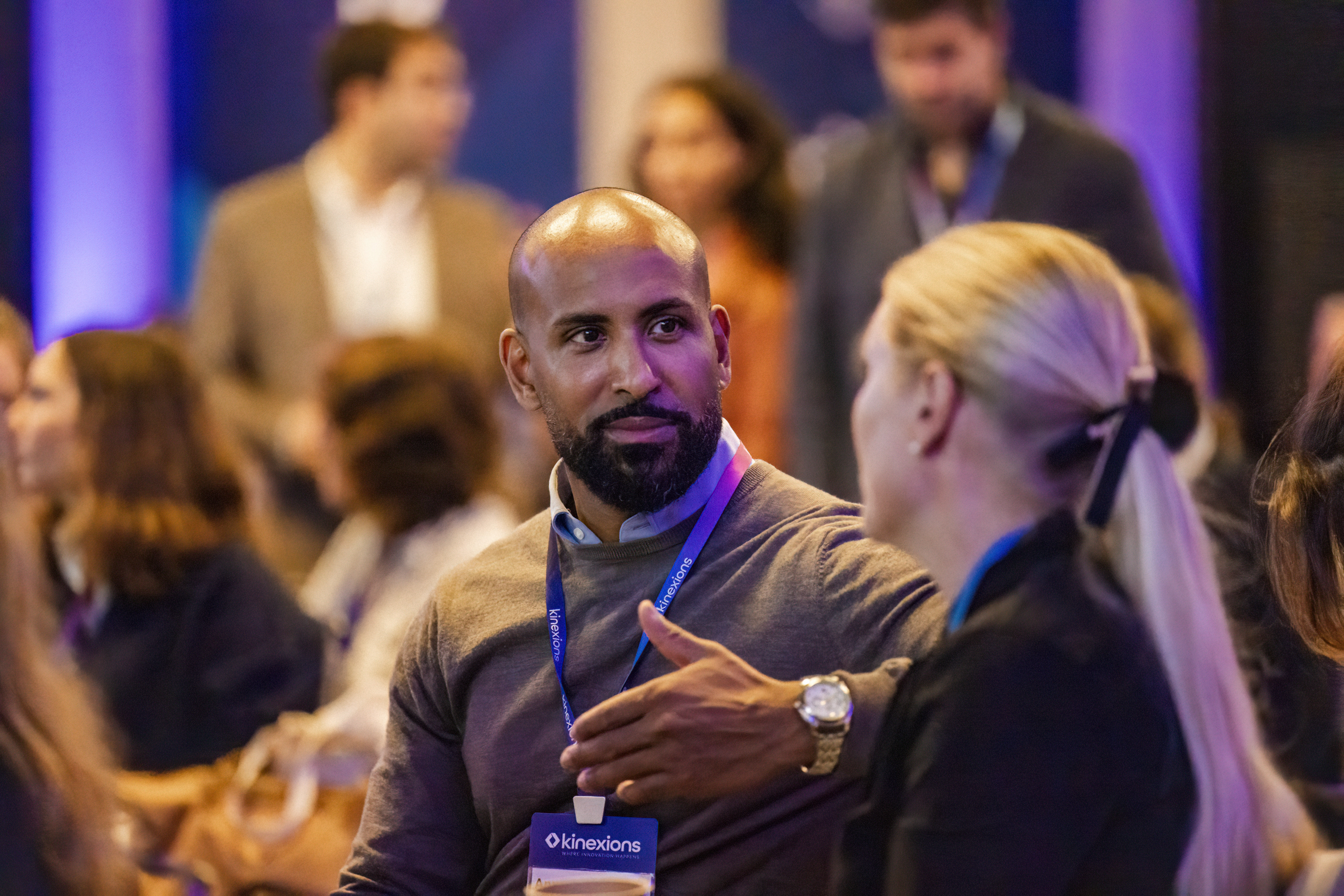 Kinexions participants engage in a conversation at the event