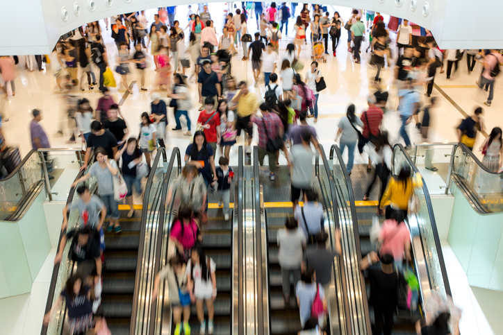 Shoppers riding a crowded escalator